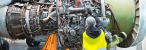 aerospace mechanic working on an engine